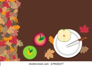 Red and green apples are lying on the table. Sliced green apple with knife are lying on the white plate. The edge forms colorful autumn leaves.