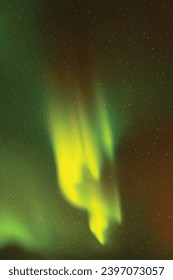 Red green aurora borealis. Night starry sky and Northern lights