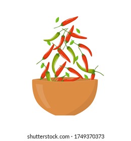 red and green chili peppers falling into a wooden bowl