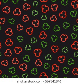 Red and green pepper slices on black background. Seamless pattern with vegetables.