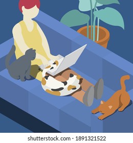 Red hair woman sitting on the sofa with laptop while working at home with three cats.