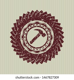Red hammer icon inside distressed rubber stamp with grunge texture