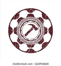 Red hammer icon inside rubber seal