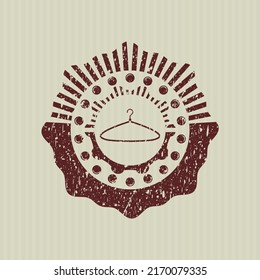 Icono del colgador rojo dentro del precinto de caucho con textura gruesa. 