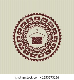 Red hanger with towel icon inside rubber stamp