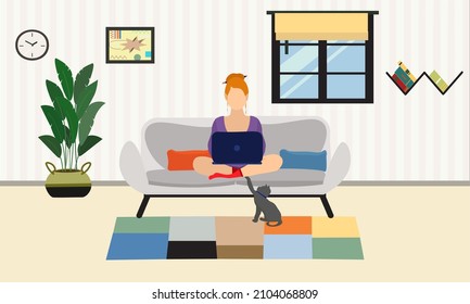 red head cat lover girl sitting on sofa working on her laptop. she is working at homaoffice. home office worker girl.