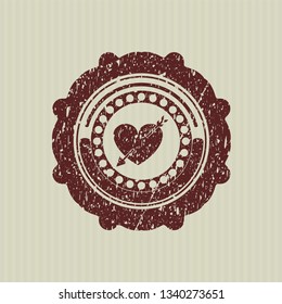 Red heart with arrow icon inside distressed rubber stamp
