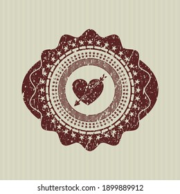 Red heart with arrow icon inside distressed grunge style stamp. 