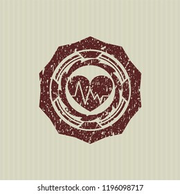 Red heart with electrocardiogram icon inside distress rubber grunge stamp