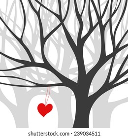 Red heart hangs on black silhouette tree