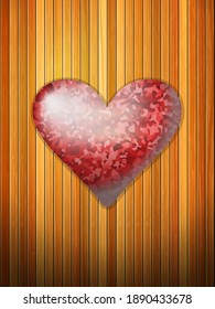 El corazón rojo sobre el fondo formado por tablas de madera.