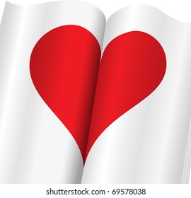 red heart on the open of the glossy notebook