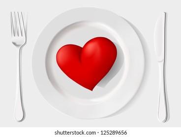 red heart on a plate, fork and knife on a white background
