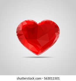 Red heart in polygonal style with shadow on a gray background