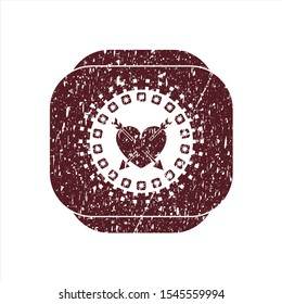 Red heart with two arrows icon inside rubber texture