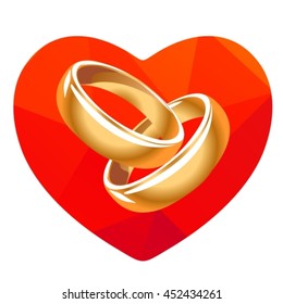 Red heart and two wedding rings isolated on a white background.