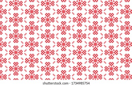 Los corazones rojos hechos de bloques cuadrados hacen un patrón floral contra un fondo blanco