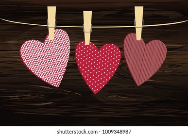 Red hearts  with a picture hanging on a rope. Valentine's Day. Vector illustration. Greeting card with empty space for your label or advertising. On a wooden background.