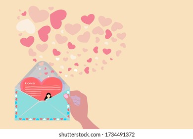 Red heart-shaped paper in the envelope was opened and many hearts spread outside. Concept of The transfer of love from a girlfriend who is far away to a lover to boost morale in the struggle in life.