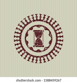 Red hourglass icon inside distress rubber grunge texture stamp