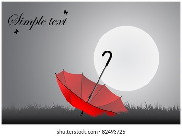Red inverted umbrella lying on the grass under a full moon shining