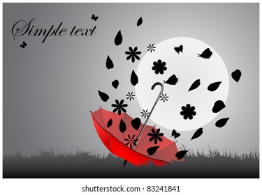 Red inverted umbrella lying on the grass with expanding foliage