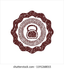Red kettlebell icon inside distressed grunge stamp