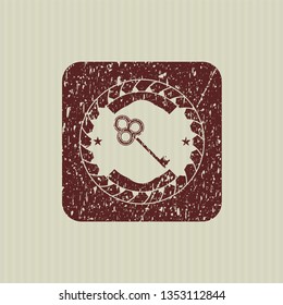 Red key icon inside distressed grunge seal