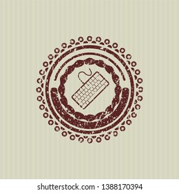 Red keyboard icon inside rubber grunge texture seal