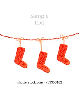 Red knitted Christmas socks on rope