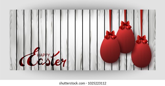Red knitted egg with a bow on a wooden background. Celebratory banner. Festive Inscription of the lettering "Happy Easter". Vecto