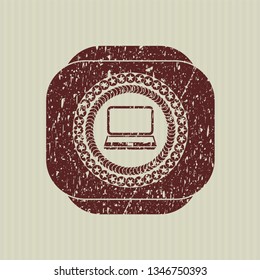 Red laptop icon inside distress rubber seal with grunge texture