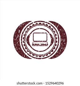 Red laptop icon inside distressed rubber grunge stamp