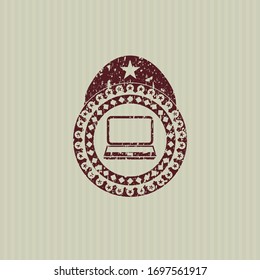 Red laptop icon inside distressed rubber grunge stamp