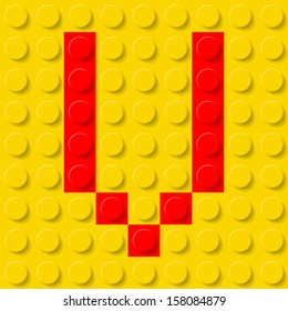 Red letter V in yellow plastic construction kit. Typeface  sample.