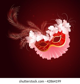 red luxurious mask with a veil and white and red fluffy feathers on a dark red background