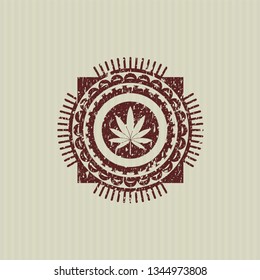 Red marijuana leaf icon inside rubber texture