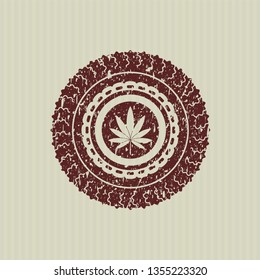 Red marijuana leaf icon inside distressed rubber stamp