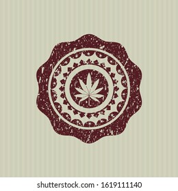 Red marijuana leaf icon inside rubber grunge stamp