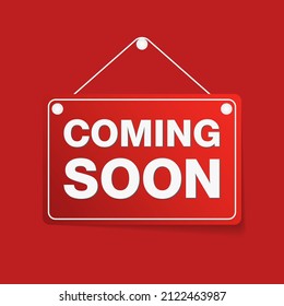 Red message announcement signboard with coming soon information text hanging on button pin isolated on red background. EPS10 illustration vector.