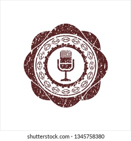 Red microphone icon inside distressed rubber stamp with grunge texture