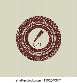 Red microphone icon inside distressed rubber seal with grunge texture