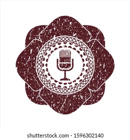 Red microphone icon inside rubber grunge stamp