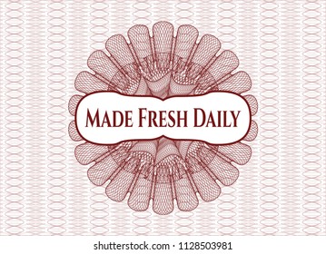 Red money style emblem or rosette with text Made Fresh Daily inside