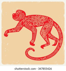 Red monkey on a beige background with scuffs.