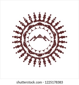 Red mountain icon inside distress rubber seal
