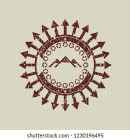 Red mountain icon inside distress rubber seal with grunge texture