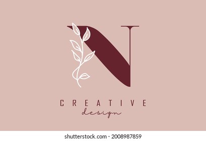Red N letter logo design with white leaves branch vector illustration. Creative and elegant icon with letter N.