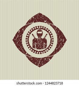 Red ninja icon inside distressed rubber texture