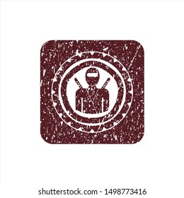 Red ninja icon inside distressed grunge stamp